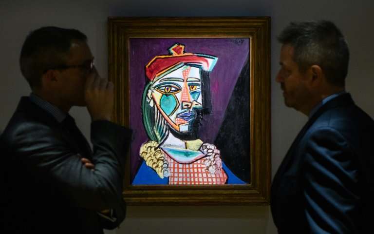 Picasso's "Femme au beret et a la robe quadrillee (Marie-Therese Walter)" displayed during an auction on February 2018. | Image source: phys.org