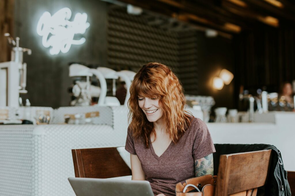 Tattooed woman on laptop by Brooke Cagle @brookecagle on Unsplash