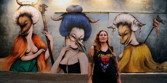 Graffiti artist Miss Van in front of her work at Wynwood Walls in Miami